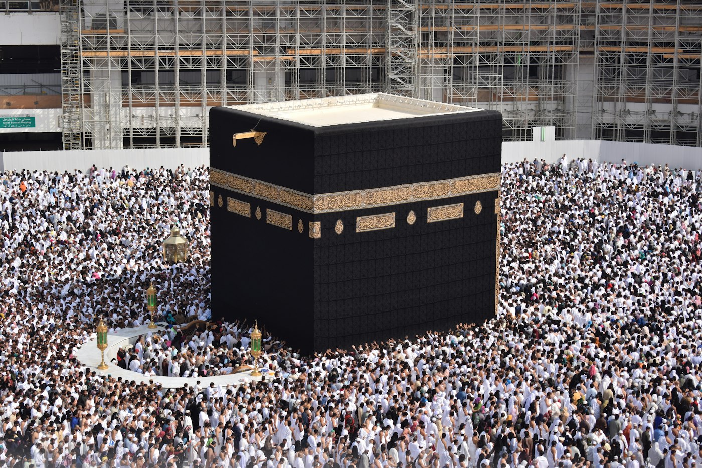 Pilgrims performing tawaf around the Kaaba under blue sky